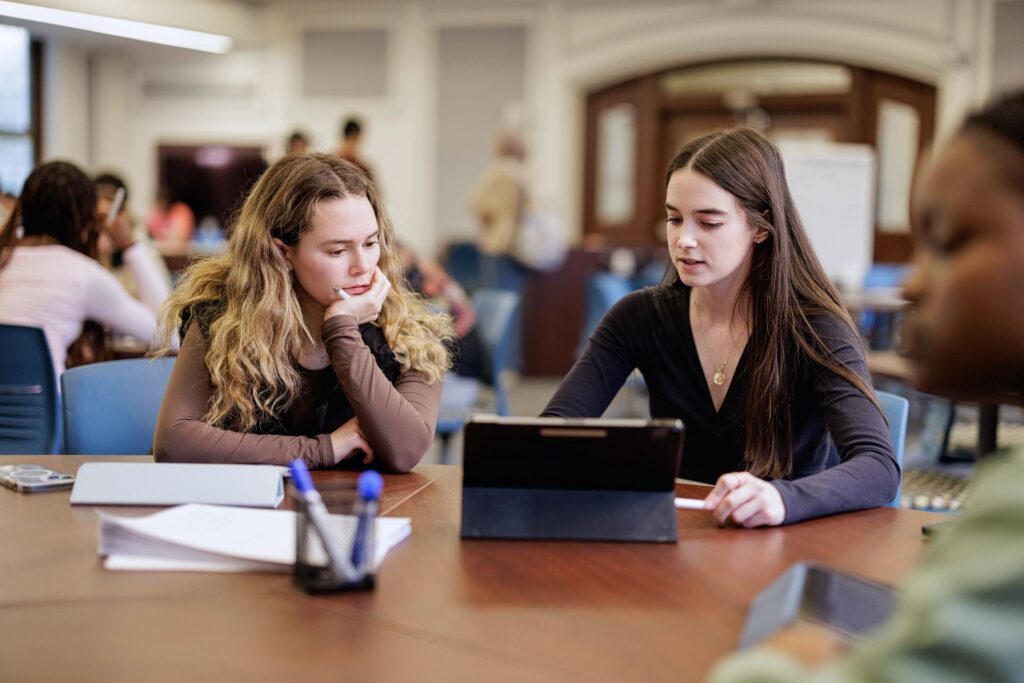 Undergraduate students work together at a table