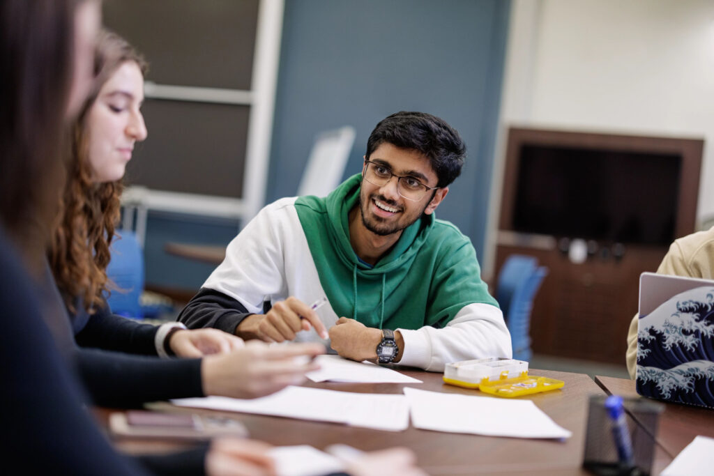 Undergraduate students work together around a table