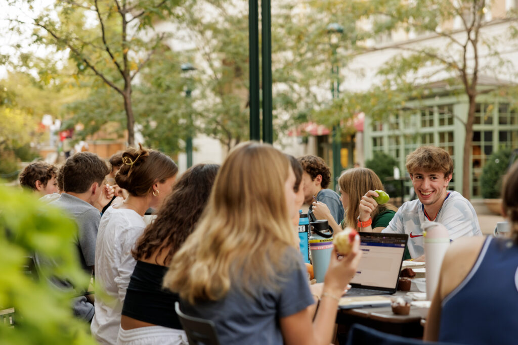 Student enjoy a meal outdoors
